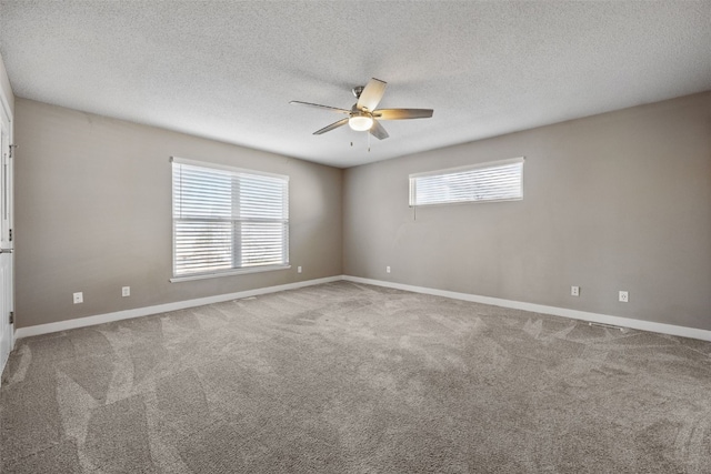 carpeted empty room with a textured ceiling, baseboards, and ceiling fan