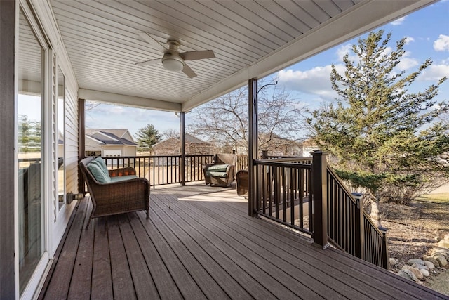 wooden deck with a ceiling fan