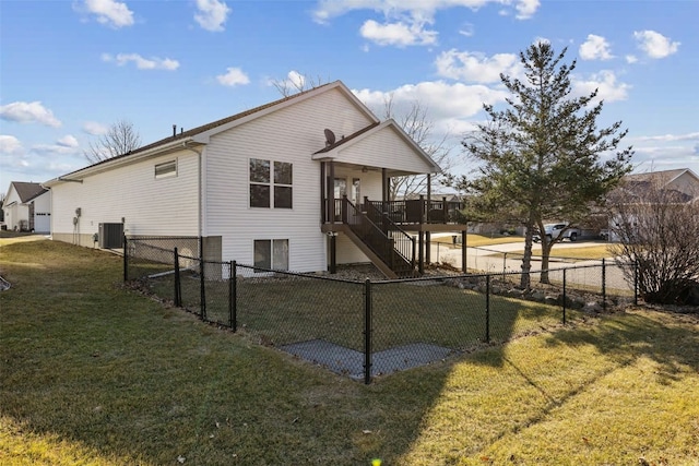 back of house featuring stairs, central air condition unit, a yard, and a fenced backyard