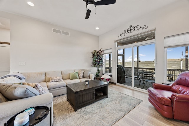 living room with visible vents, recessed lighting, light wood-type flooring, and a ceiling fan