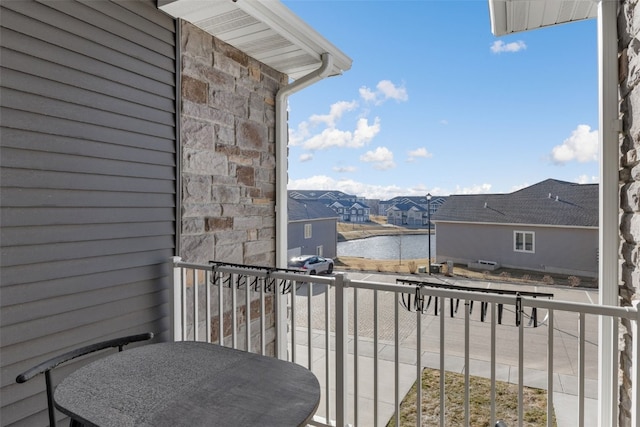 balcony with a water view and a residential view