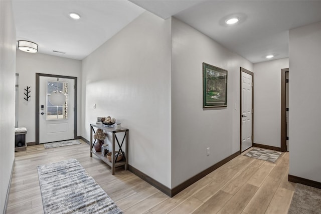 entrance foyer with recessed lighting, light wood-style flooring, and baseboards