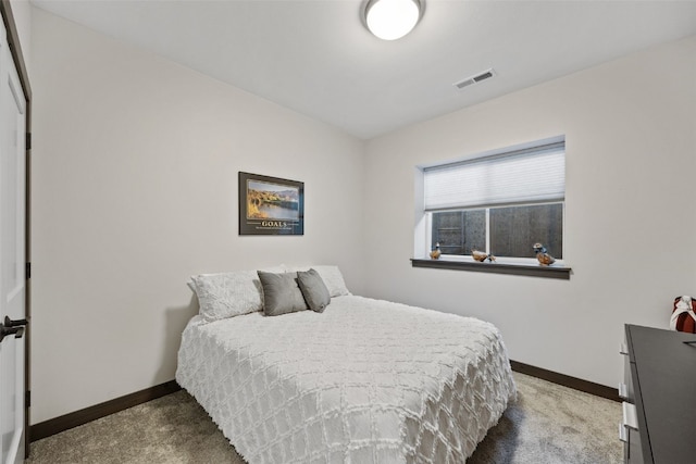 carpeted bedroom featuring visible vents and baseboards