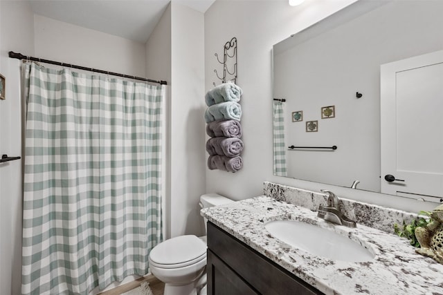 full bath featuring vanity, a shower with shower curtain, toilet, and wood finished floors