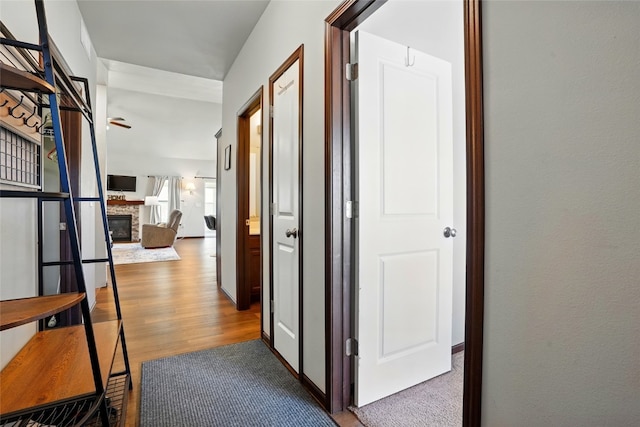 hallway featuring baseboards and wood finished floors