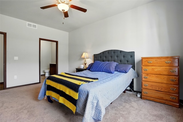 bedroom featuring visible vents, a ceiling fan, ensuite bath, carpet, and baseboards