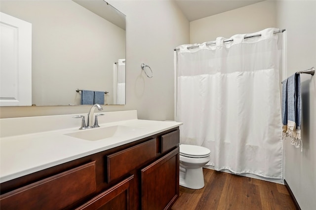 bathroom with curtained shower, toilet, vanity, and wood finished floors