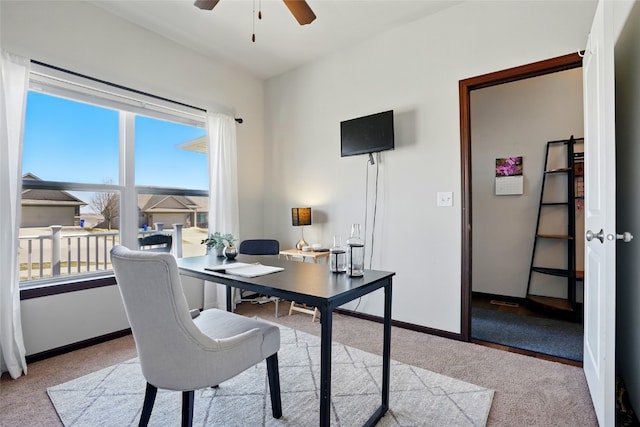 home office with baseboards, a ceiling fan, and carpet floors