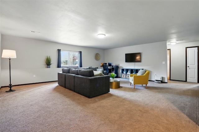 carpeted living area with visible vents and baseboards