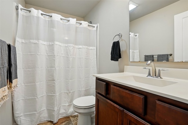 bathroom featuring toilet and vanity