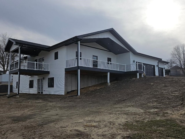 rear view of house featuring an attached garage