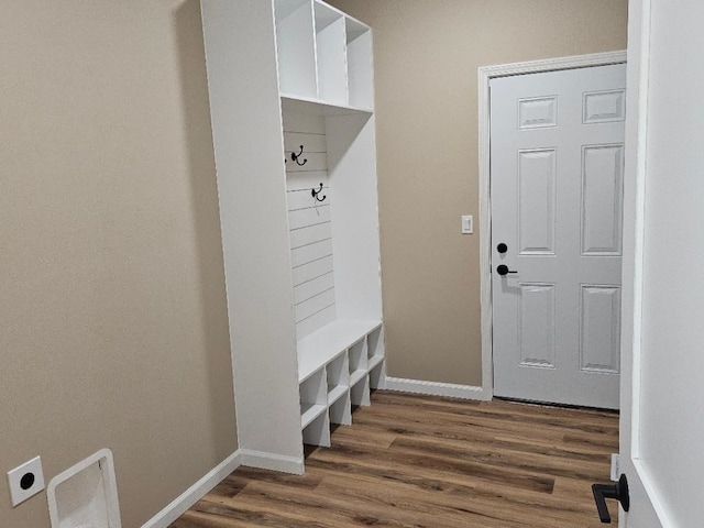 mudroom with dark wood-type flooring and baseboards