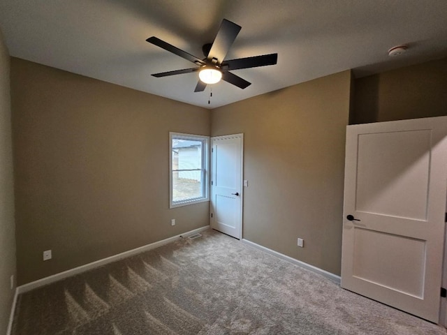 unfurnished bedroom with visible vents, baseboards, ceiling fan, and carpet flooring