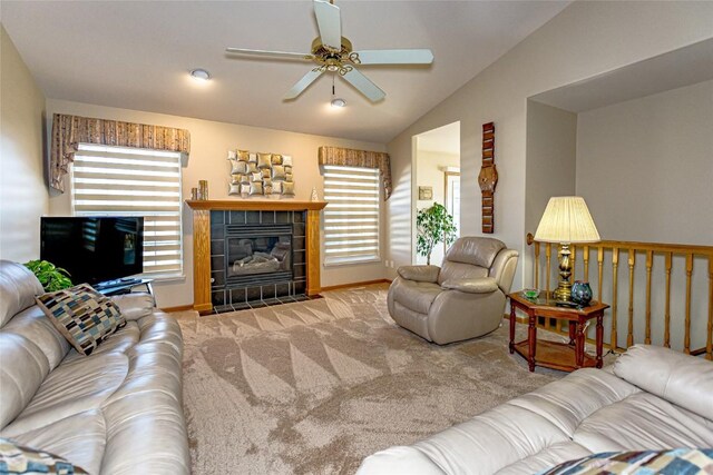 living area with lofted ceiling, carpet, a ceiling fan, and a tile fireplace