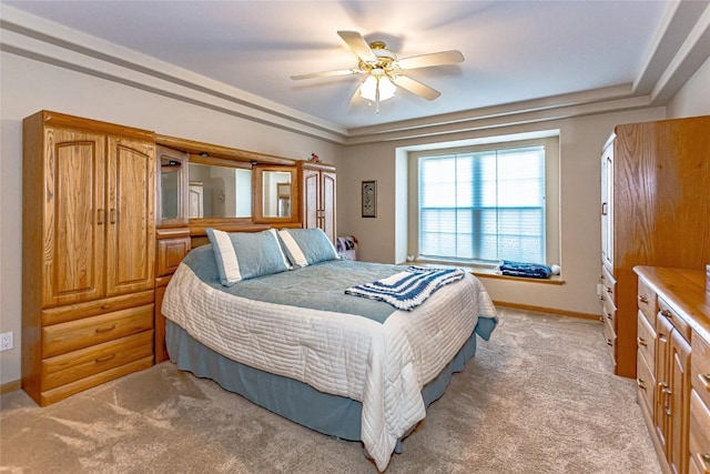 bedroom with light carpet, ceiling fan, and baseboards