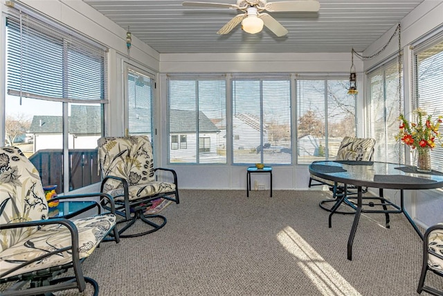 sunroom featuring ceiling fan