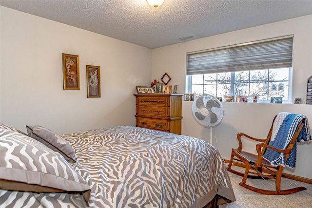 carpeted bedroom featuring visible vents and a textured ceiling