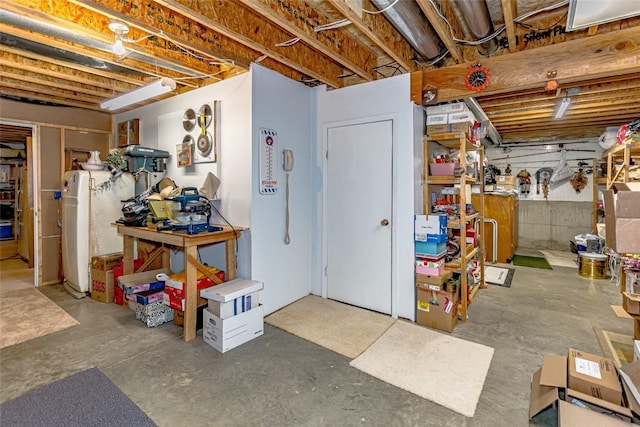 unfinished basement featuring a workshop area