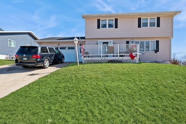 rear view of property featuring concrete driveway, a yard, a garage, and a wooden deck