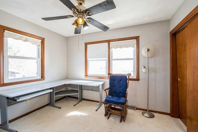 office area with baseboards, plenty of natural light, light carpet, and ceiling fan