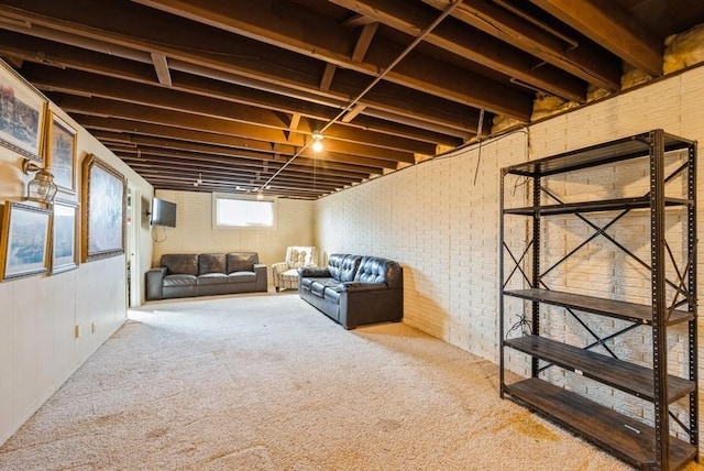 basement with carpet flooring and brick wall