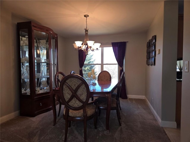 carpeted dining room featuring baseboards and a chandelier