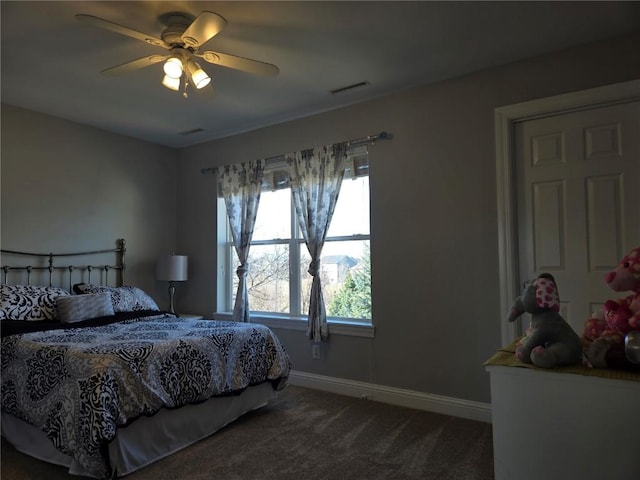 carpeted bedroom with visible vents, a ceiling fan, and baseboards