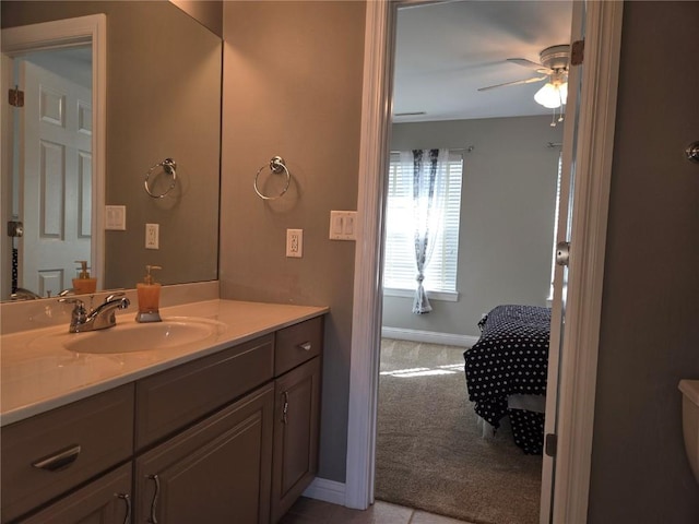 bathroom featuring vanity, a ceiling fan, and baseboards