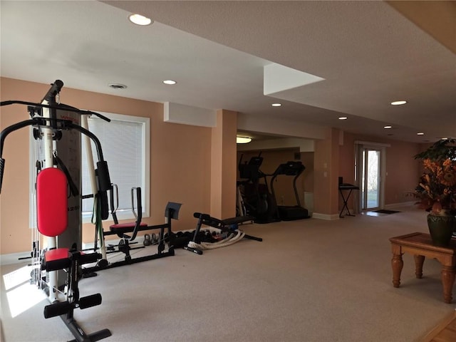 exercise area featuring recessed lighting and baseboards