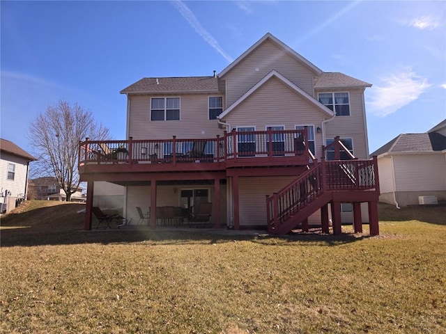 back of property featuring stairway, a yard, and a wooden deck