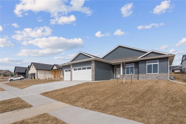 ranch-style house featuring a front yard, central air condition unit, an attached garage, and driveway