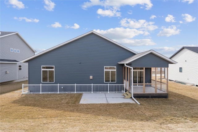 back of property featuring a lawn and a patio area