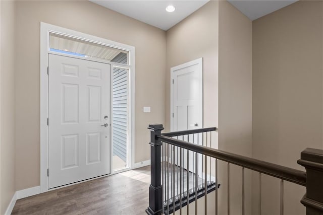 foyer with baseboards and wood finished floors