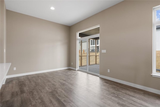 spare room with recessed lighting, wood finished floors, and baseboards