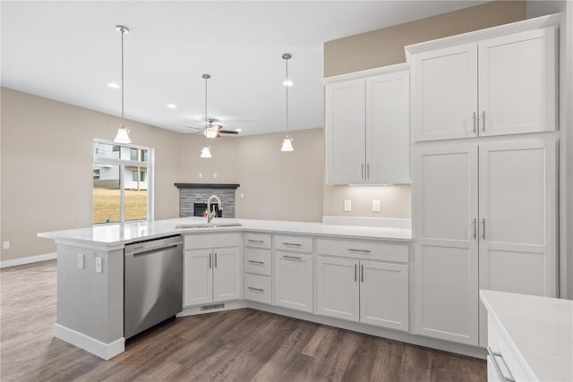 kitchen with light countertops, stainless steel dishwasher, white cabinetry, a ceiling fan, and a sink