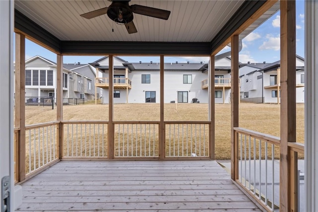 wooden deck with a ceiling fan and a residential view