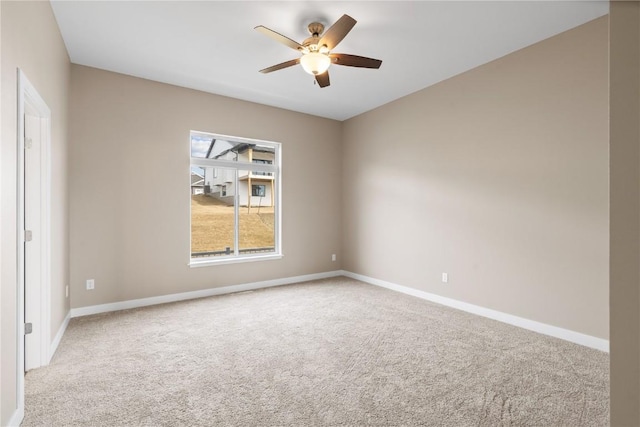 carpeted empty room with baseboards and ceiling fan