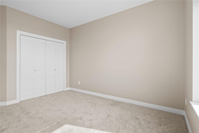 unfurnished bedroom with carpet and baseboards