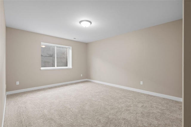 spare room with carpet flooring and baseboards