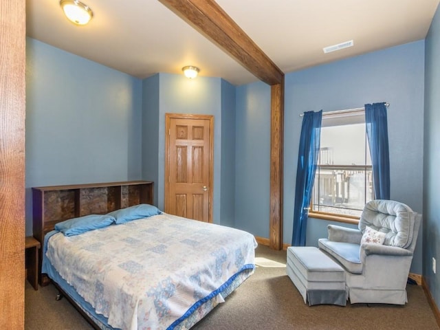 carpeted bedroom featuring beam ceiling, visible vents, and baseboards