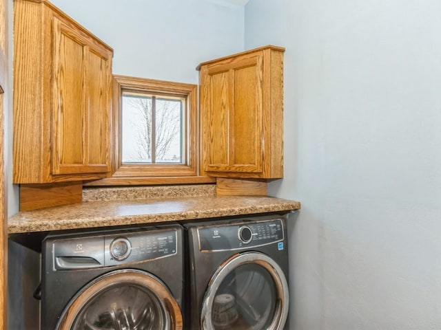 laundry area with cabinet space and independent washer and dryer