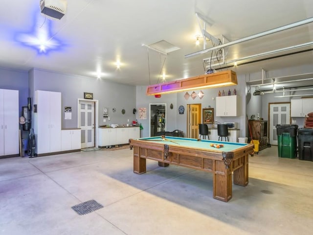 playroom with billiards, a garage, and concrete floors