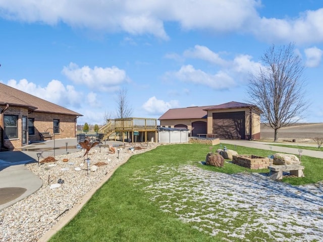 view of yard featuring a patio area, concrete driveway, and stairs