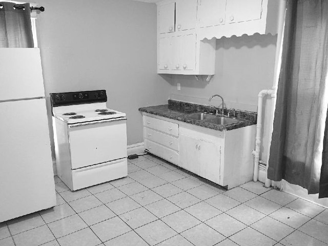 512/514 Mckinley St SE, Cedar Rapids, IA 52403 - kitchen with white appliances, a sink, white cabinetry, dark countertops, and light tile patterned floors