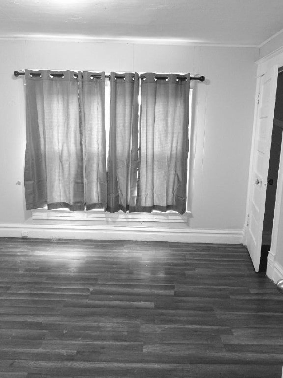 spare room with wood finished floors and baseboards