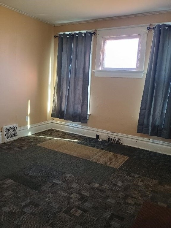 carpeted spare room with baseboards