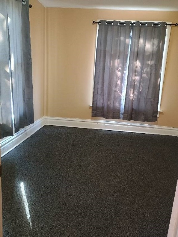 spare room with baseboards