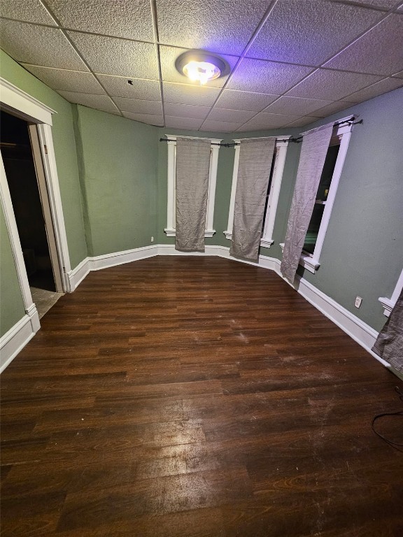 1416/1418 3rd Ave SE, Cedar Rapids, IA 52403 - empty room with a paneled ceiling, wood finished floors, and baseboards