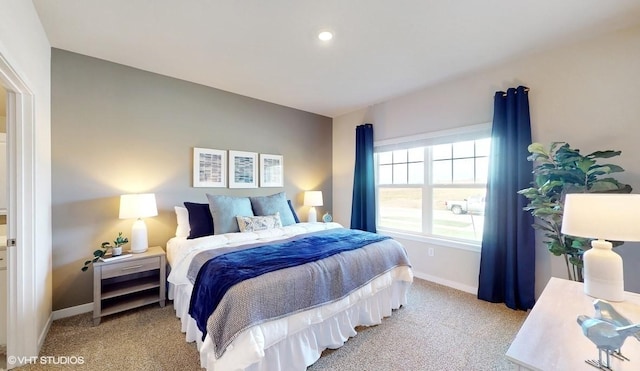 carpeted bedroom featuring baseboards