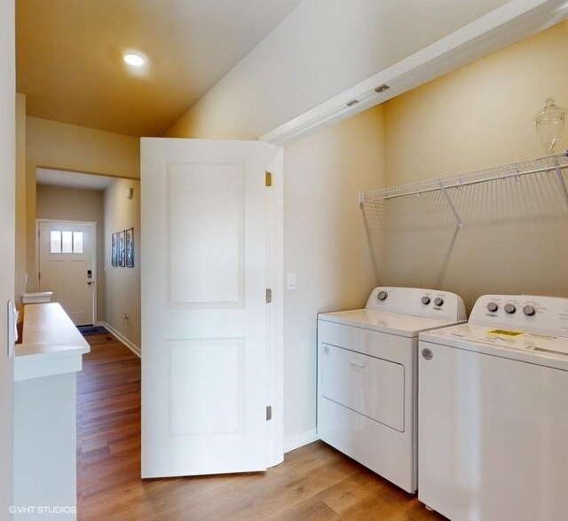 clothes washing area featuring independent washer and dryer, light wood-style flooring, baseboards, laundry area, and recessed lighting
